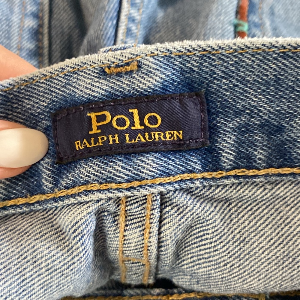 These jeans are straight leg jeans with patches, rips, and intricate designs